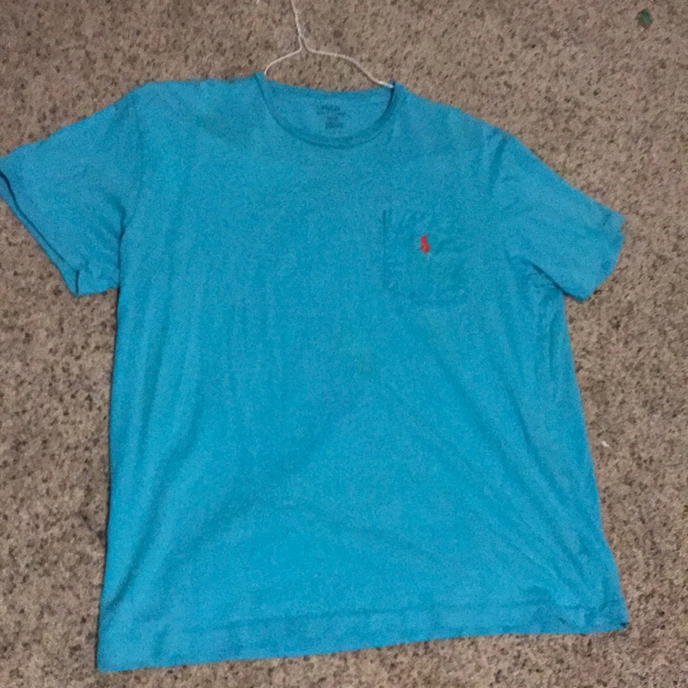 Blue polo shirt with orange logo and chest pocket